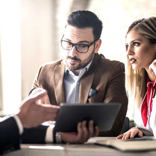 people looking into a tablet