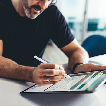 man typing in his tablet