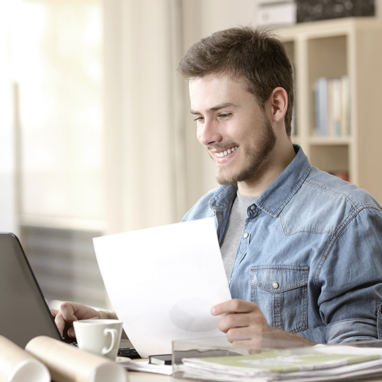man looking into a screen 